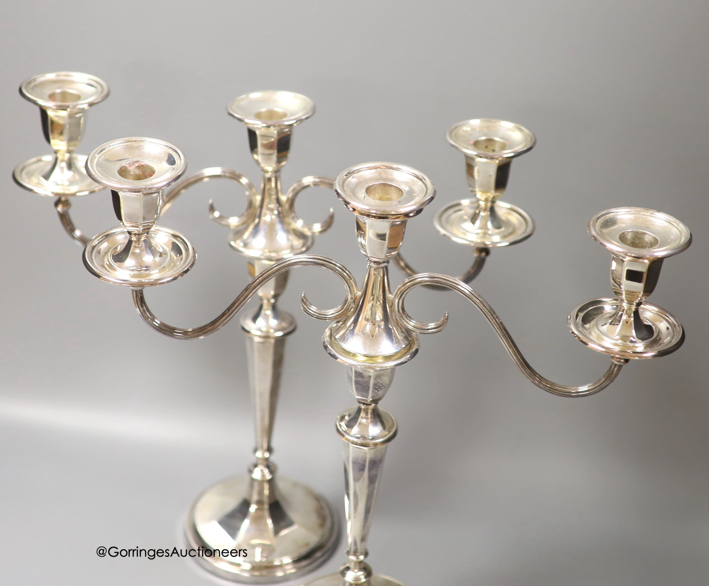 A modern pair of silver two branch, three light candelabra by C.J. Vander Ltd, Sheffield, 1962 & 1964, height 37cm, weighted (a.f.)